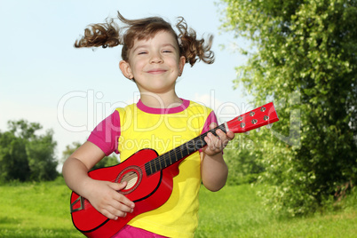 little girl play guitar outdoor
