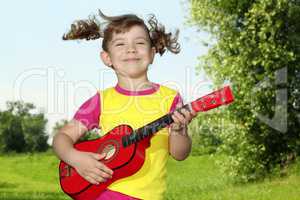little girl play guitar outdoor