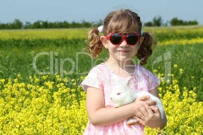 little girl holding white dwarf bunny