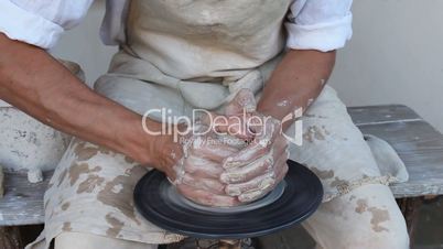 potter making clay jug