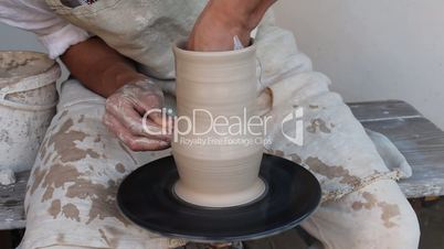 potter making clay jug