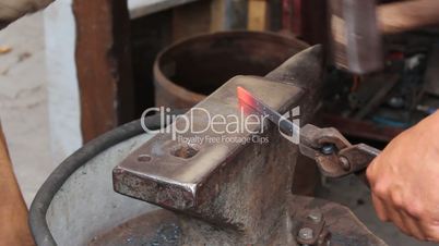blacksmiths forges a horseshoe
