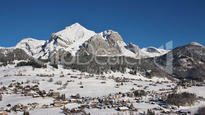 Snow covered Mt Säntis and village Wildhaus