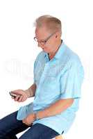Older man looking at his cell phone.