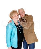 Older man hugging his wife.