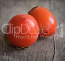 persimmons on wooden table
