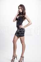 Young slim sexy woman in black dress isolated on white backgroun