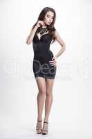 Young slim sexy woman in black dress isolated on white backgroun