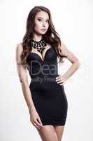 Young slim sexy woman in black dress isolated on white backgroun