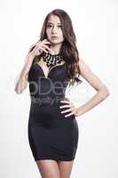 Young slim sexy woman in black dress isolated on white backgroun