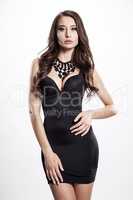 Young slim sexy woman in black dress isolated on white backgroun