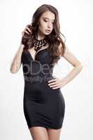 Young slim sexy woman in black dress isolated on white backgroun