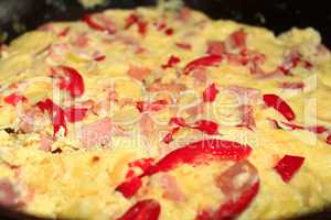 cooking of omelet with red paprika