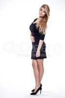 Young slim sexy woman in black dress isolated on white backgroun