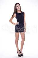 Young slim sexy woman in black dress isolated on white backgroun