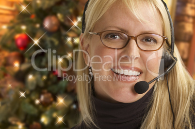 Woman with Phone Headset In Front of Christmas Tree