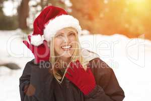 Attractive Santa Hat Wearing Blond Woman Having Fun in Snow