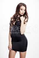 Young slim sexy woman in black dress isolated on white backgroun