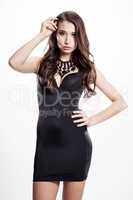 Young slim sexy woman in black dress isolated on white backgroun