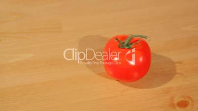 A tomato on a cutting board