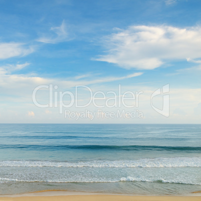 ocean, sandy beach and blue sky