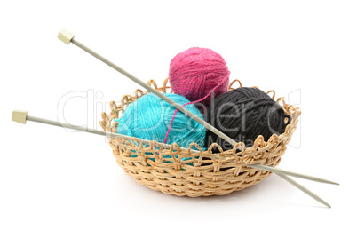 Multicolored balls and needles in basket