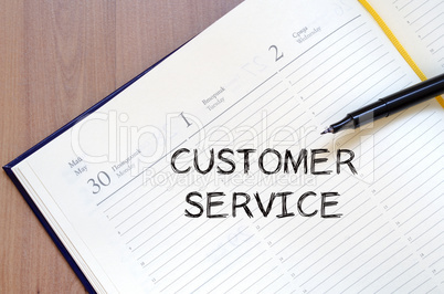 Customer service write on notebook