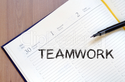 Teamwork write on notebook