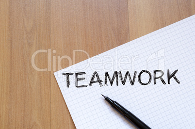 Teamwork write on notebook