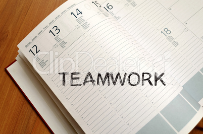 Teamwork write on notebook