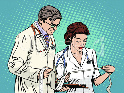 Doctor and nurse looking cardiogram