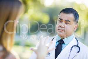 Hispanic Male Doctor or Nurse Talking With a Patient