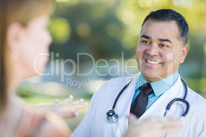 Hispanic Male Doctor or Nurse Talking With a Patient
