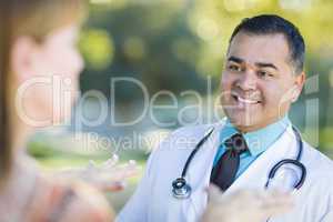 Hispanic Male Doctor or Nurse Talking With a Patient