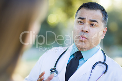 Hispanic Male Doctor or Nurse Talking With a Patient