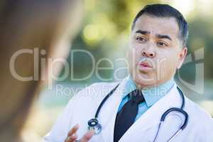Hispanic Male Doctor or Nurse Talking With a Patient
