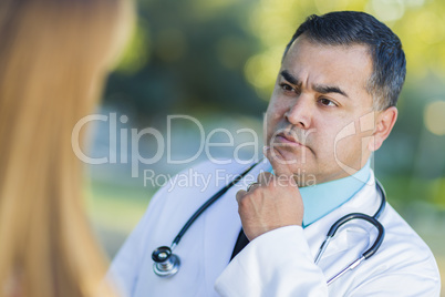 Hispanic Male Doctor or Nurse Talking With a Patient