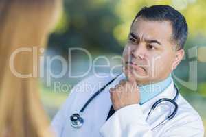 Hispanic Male Doctor or Nurse Talking With a Patient