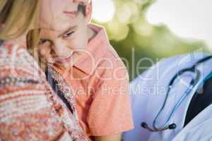 Sick Mixed Race Boy, Mother and Hispanic Doctor Outdoors