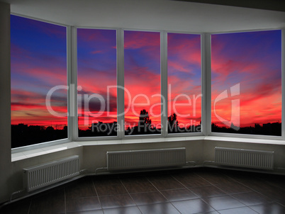 big office windows with sunset beyond it