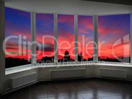 big office windows with sunset beyond it