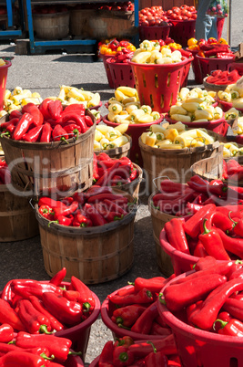 Red and yellow peppers in barrels