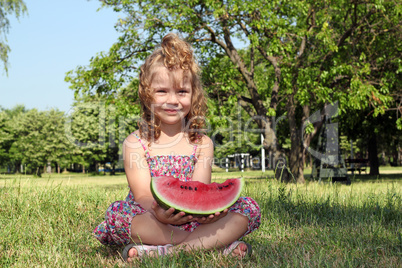 little girl holding watermelon