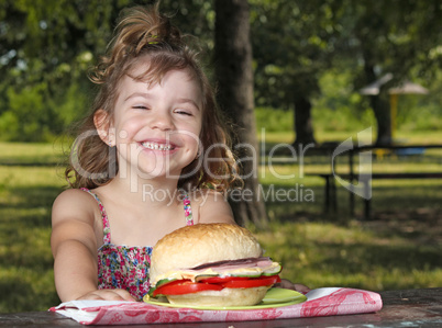 happy little girl picnic in park