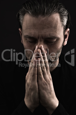 Sad man praying