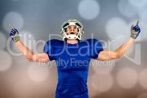 Composite image of happy american football player with arms outs