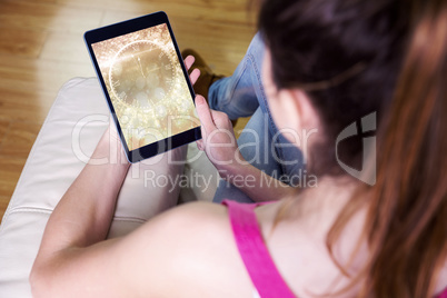 Composite image of woman using tablet at home