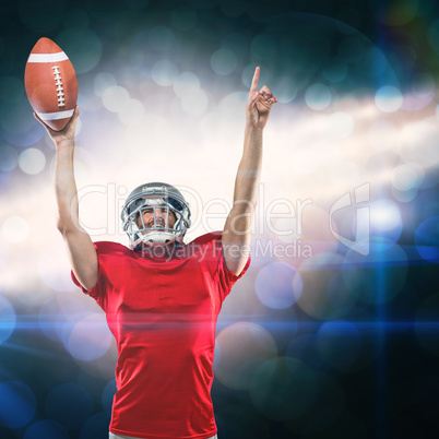 Composite image of american football player with holding ball arms raised