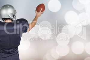 Composite image of rear view of sports player holding ball