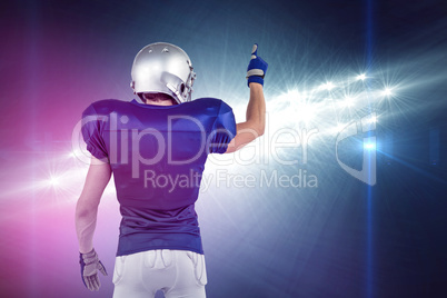 Composite image of rear view of american football player pointin